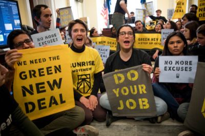 Supporters of climate action with Green New Deal signs