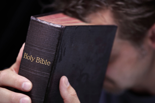 Man holding Bible.