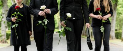 Mourners With Flowers Attending a Humanist Funeral