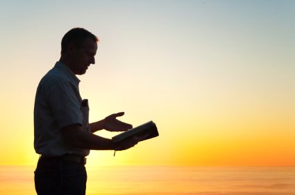 A ULC minister preaching at twilight