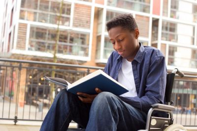 Boy in a Wheelchair Reading a Book