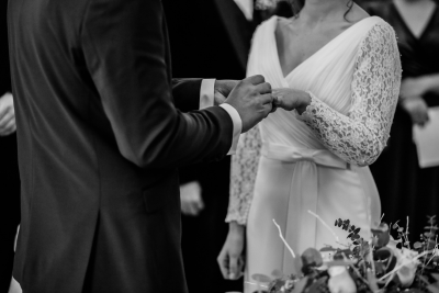 Bride and groom exchange rings during their wedding ceremony.