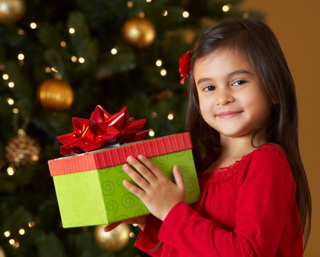 A child holding a Christmas gift