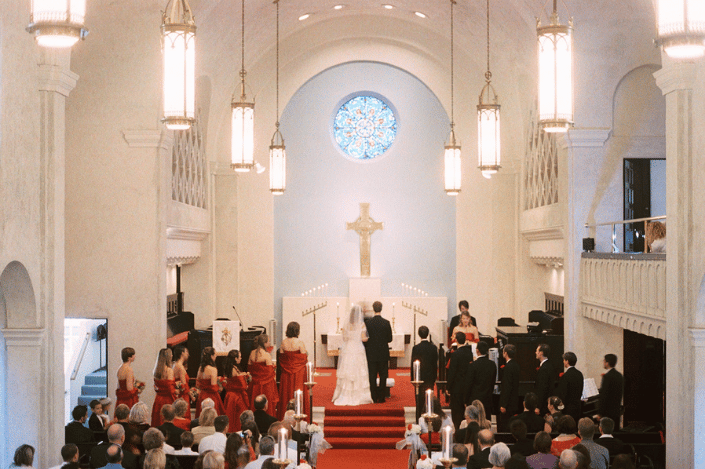 Couple getting married during a Christian wedding ceremony inside a church