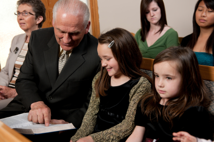 Children and their grandfather worship in a nondenominational church