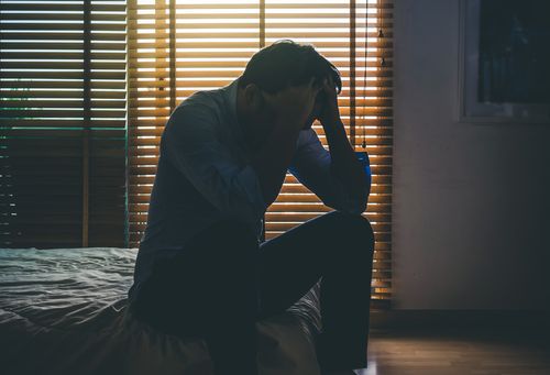 Depressed Person Sitting in a Dark Room