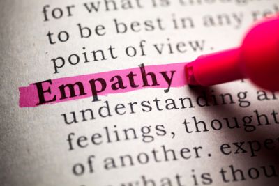 Someone highlighting the word Empathy in the dictionary