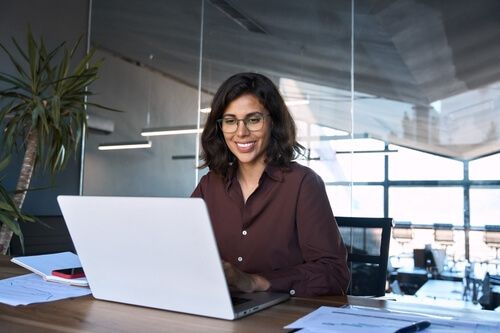 A smiling woman using  computer technology