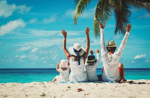 Family Sitting Under a Palm Tree