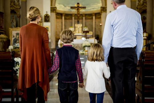 A Family Walking Into Church