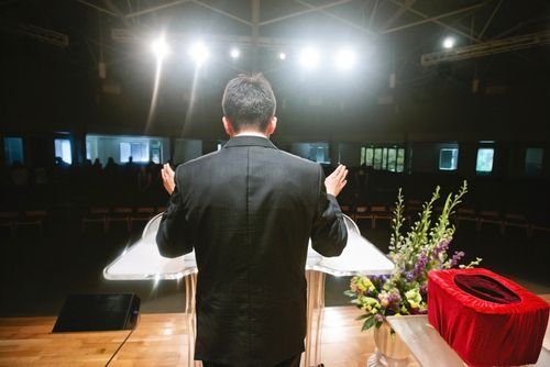 A pastor giving one of many sermons to his congregation