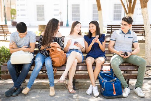 A Group of Gen Z-ers sitting on a secular bench