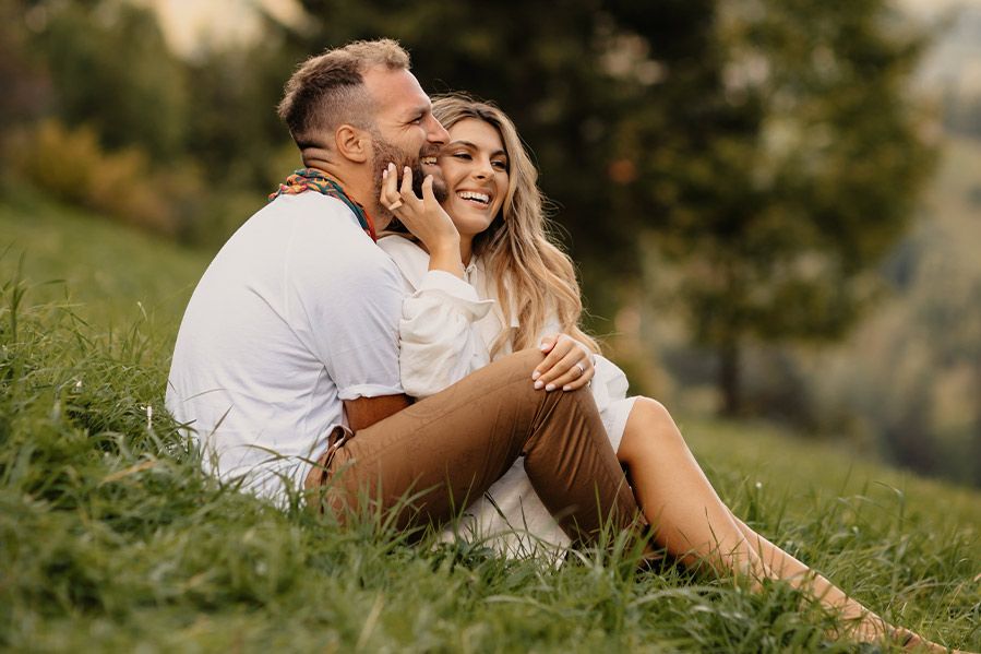 A happy couple after eloping in a forest field.