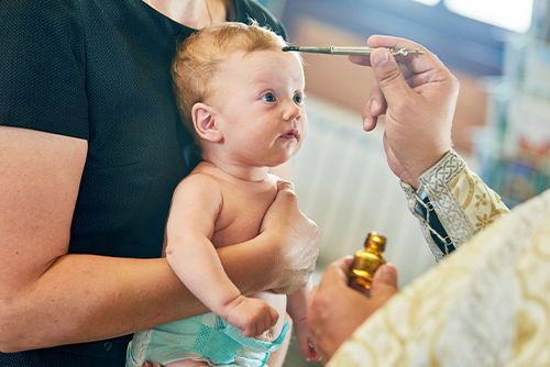 infant during anointing ceremony