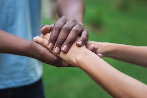 Kindness expressed with two people holding hands