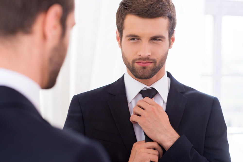 Man adjusting his tie