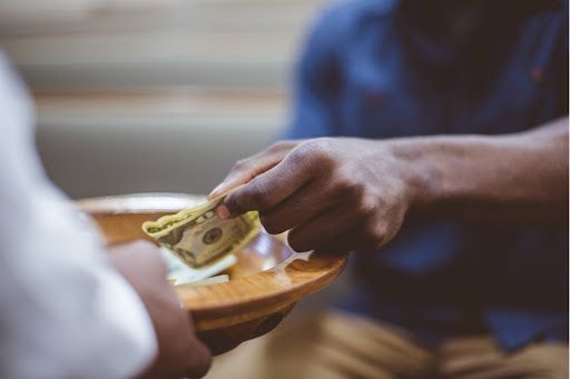 Man donating money to church