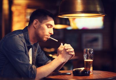 Man Smoking and Drinking