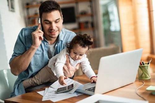 Man With Baby Working From Home