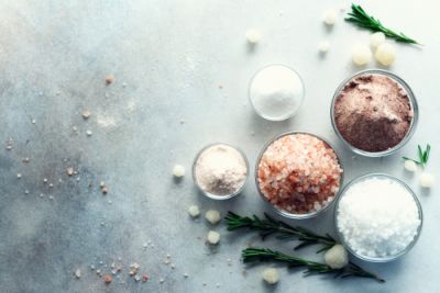 A variety of salt next to herbs