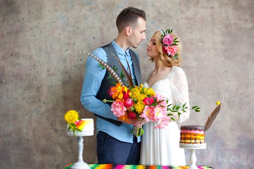 Newlyweds With Two Small Cakes