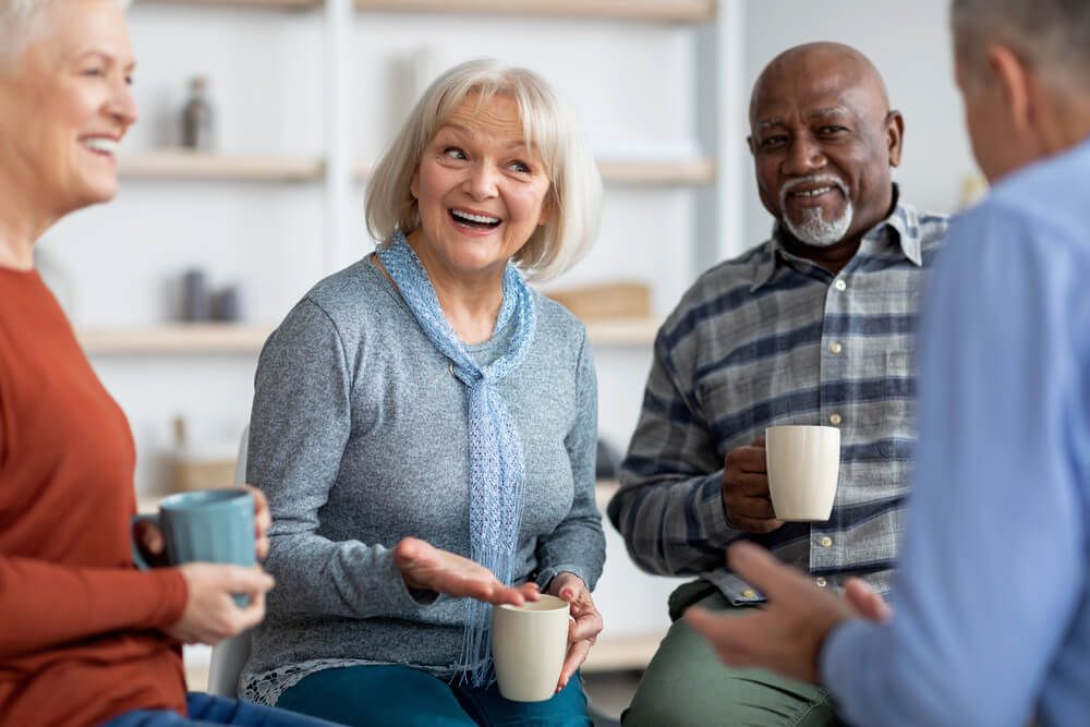 A group of older people drinking coffee and chatting