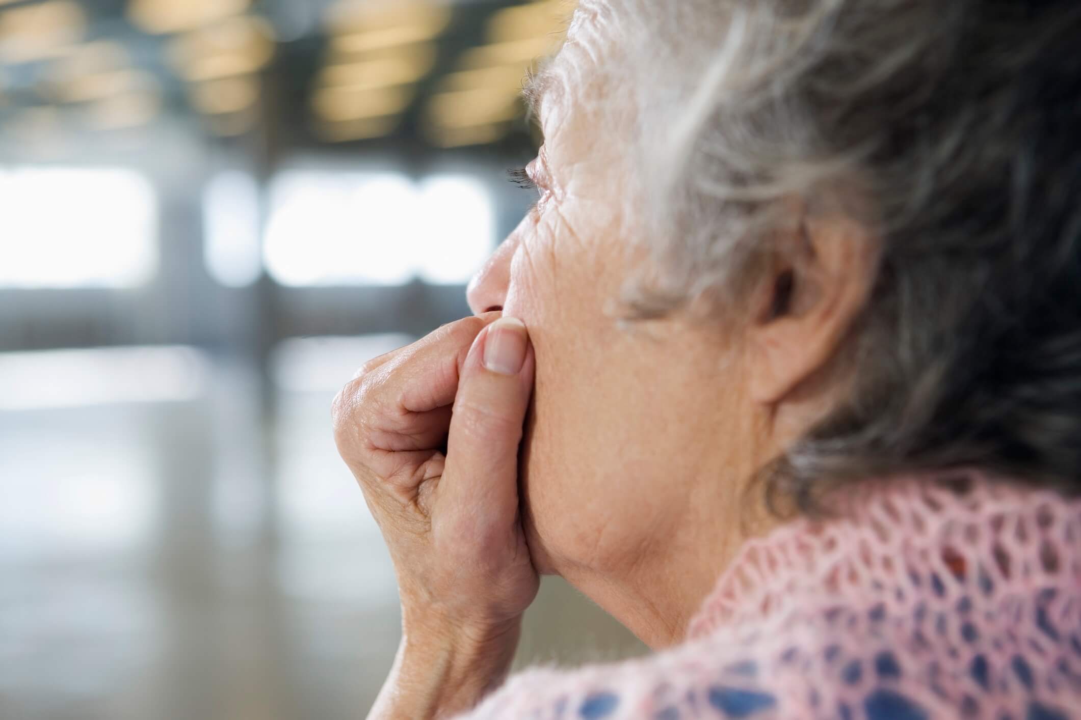 Close up of a depressed old woman