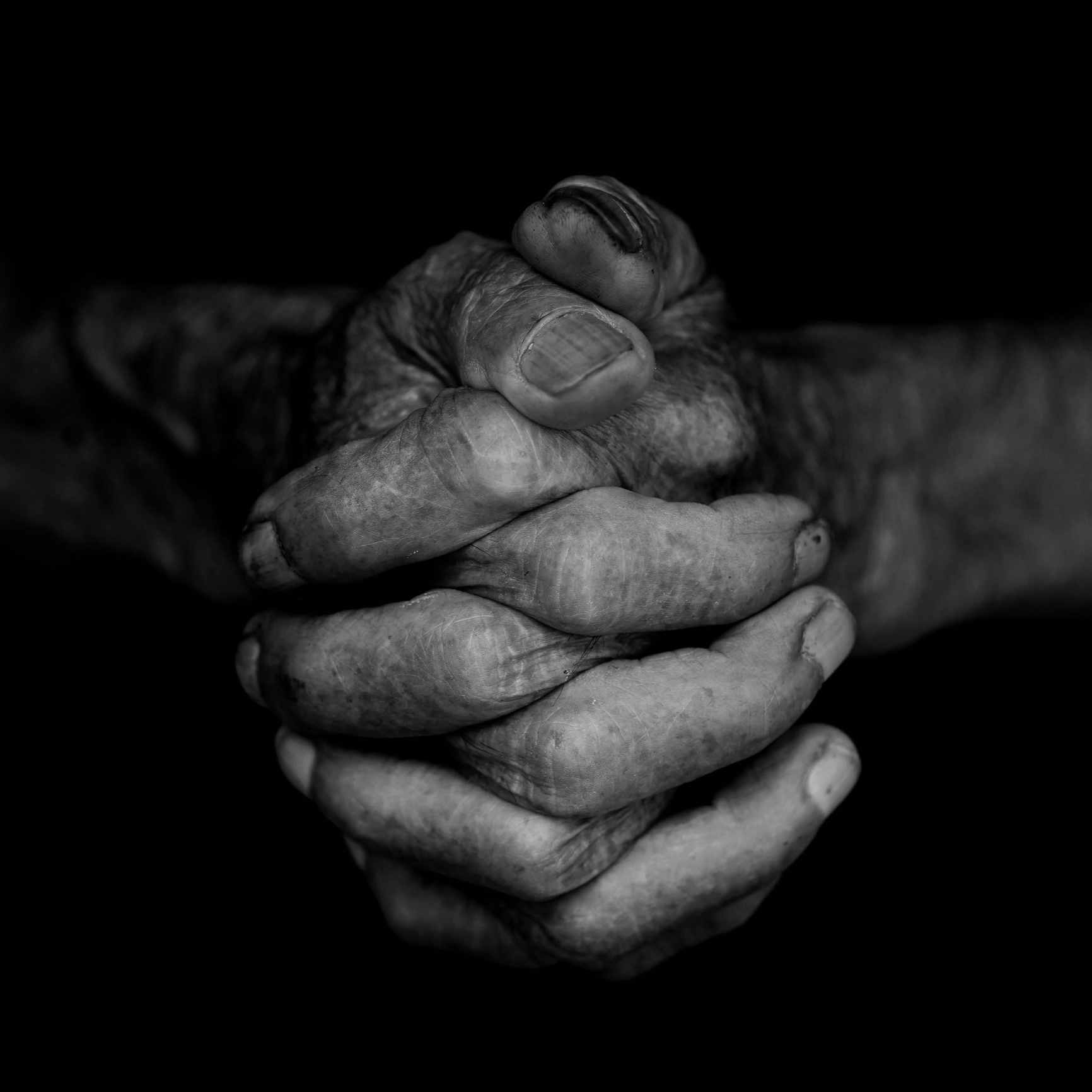 An elderly person praying