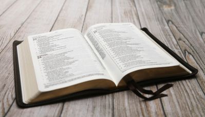 Open Bible on Wood Table