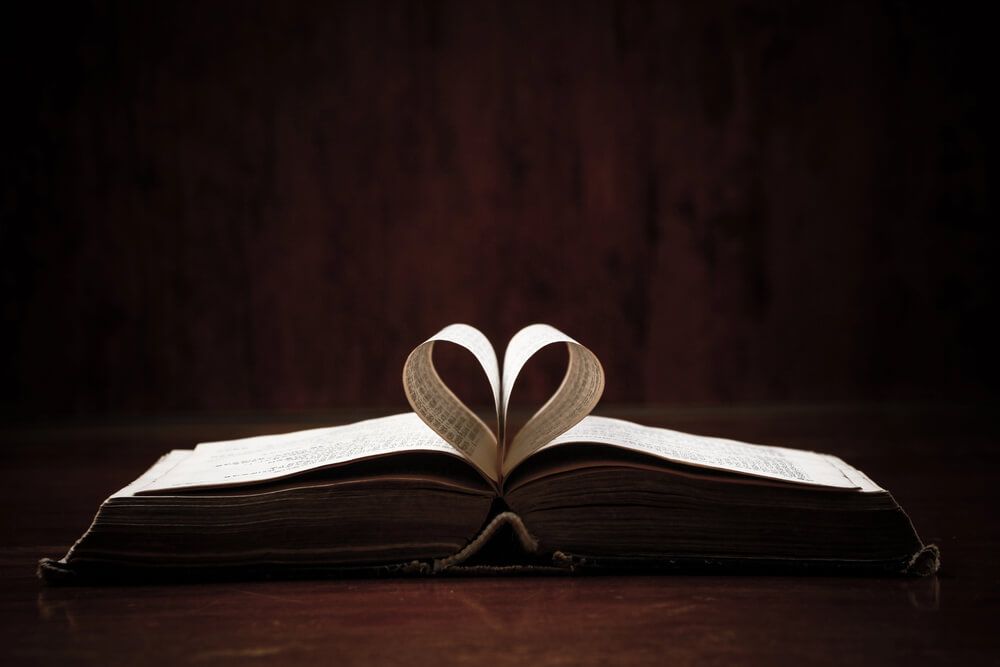 An open Bible with center pages as a heart.