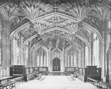 Historic interior of the Divinity School at the University of Oxford with vaulted ceiling and wooden seating.