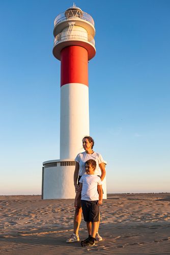 Parent and Child in Front of a Lighthouse