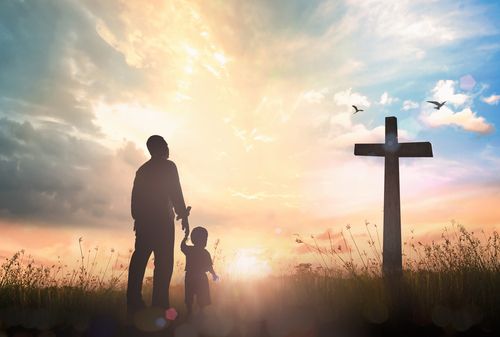 Parent and Child Looking at Cross