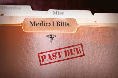 A file of medical bills stamped as past due