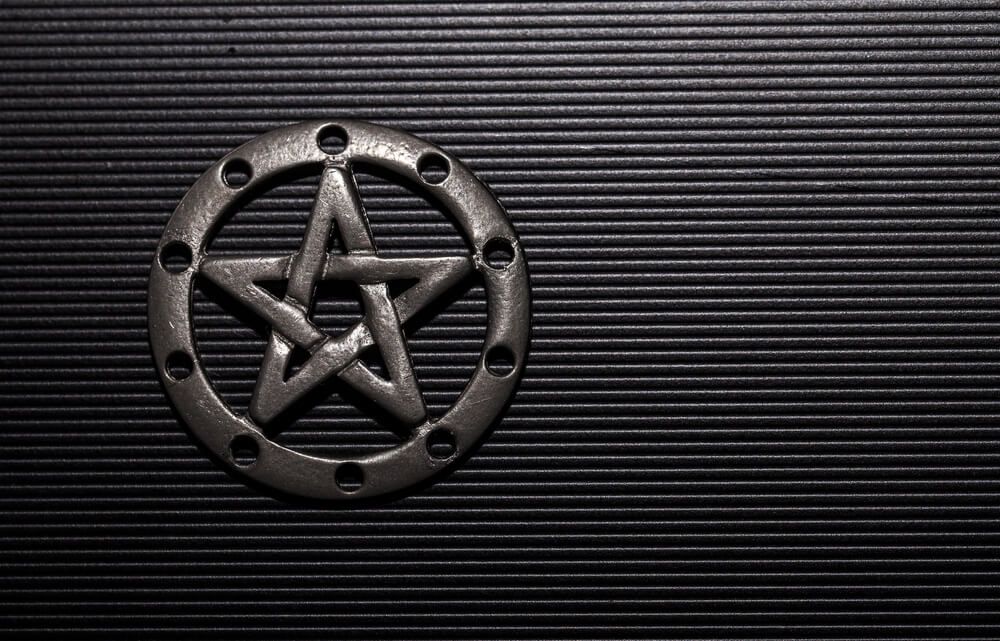 A pentacle on a dark background.