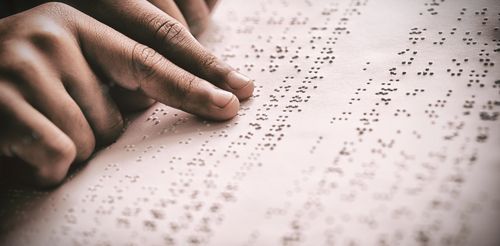 Person Reading Braille Representing Accessibility