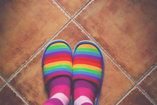 Person Wearing Rainbow Slippers