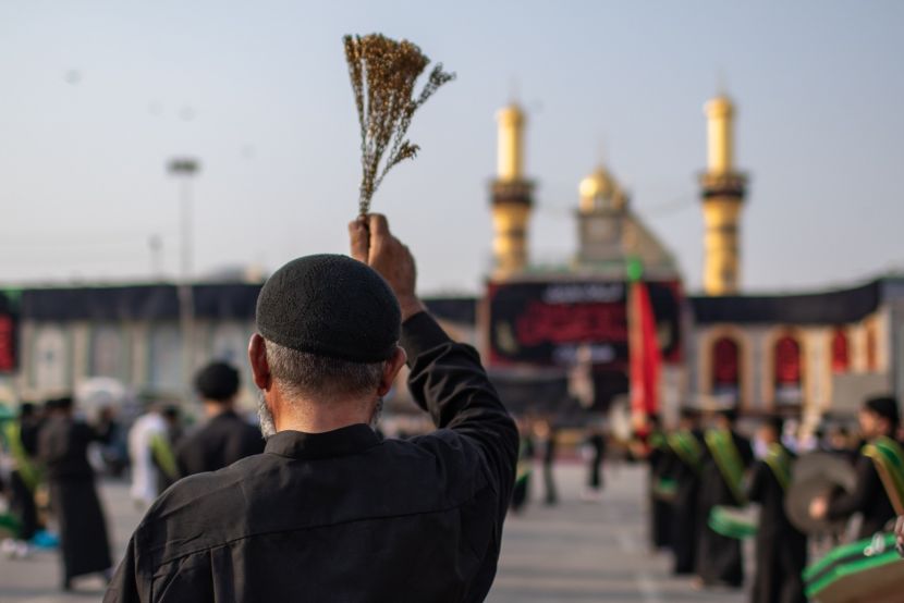 A pilgrim holds a zanjeer (chain) during Ashura commemorations at the Imam Hussain shrine in Karbala, honoring the martyrdom of Imam Hussain.