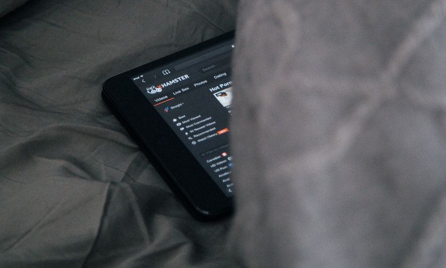 blanket partially covering device watching porn