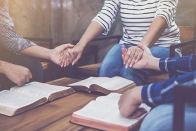 A Christian Prayer Group Holding Hands