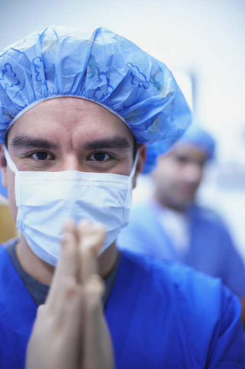 A man in scrubs praying