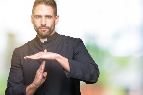 Priest Giving the Time-Out Sign