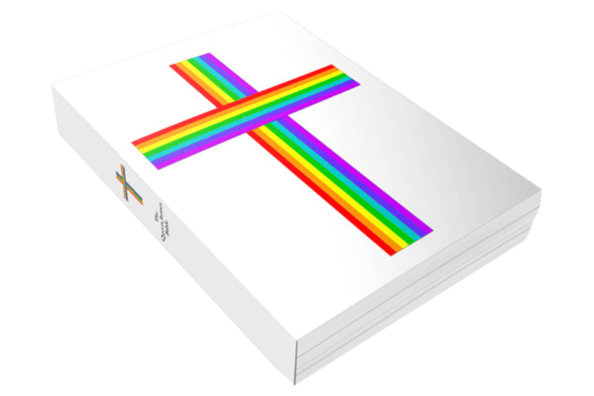 Queen James Bible with a rainbow cross on the white cover