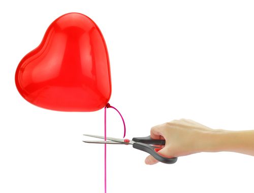 letting go of your expectations symbolized by cutting a balloon string