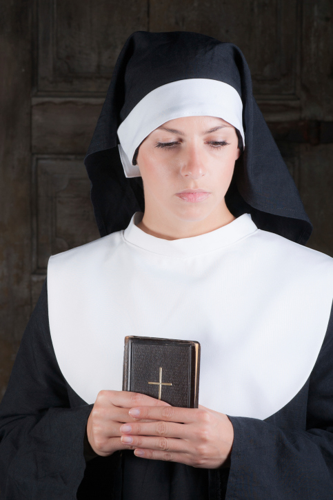 Nun with Bible looking down