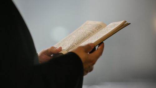 a close up shot of hands holding a code of ethics