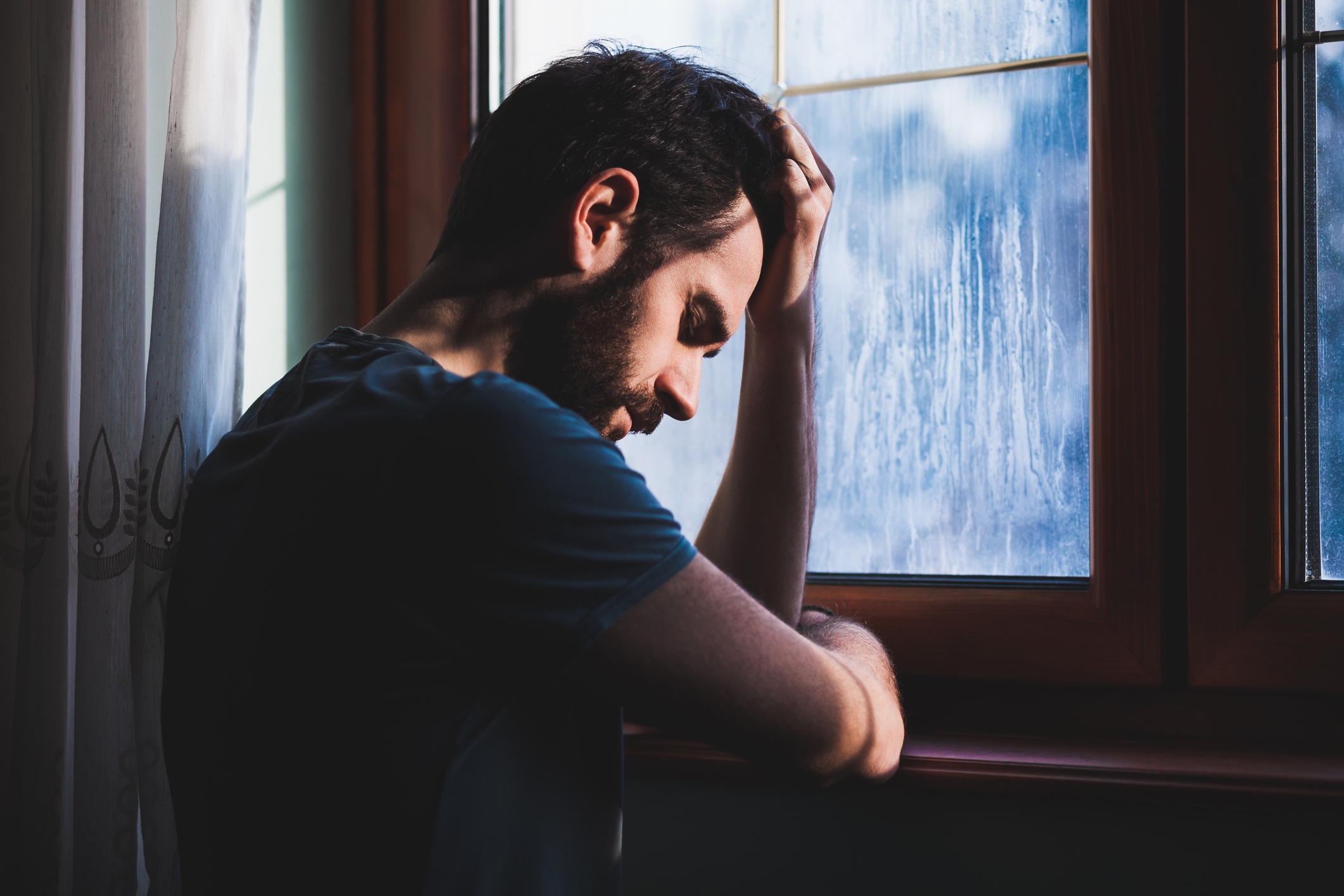 A young man grieving alone