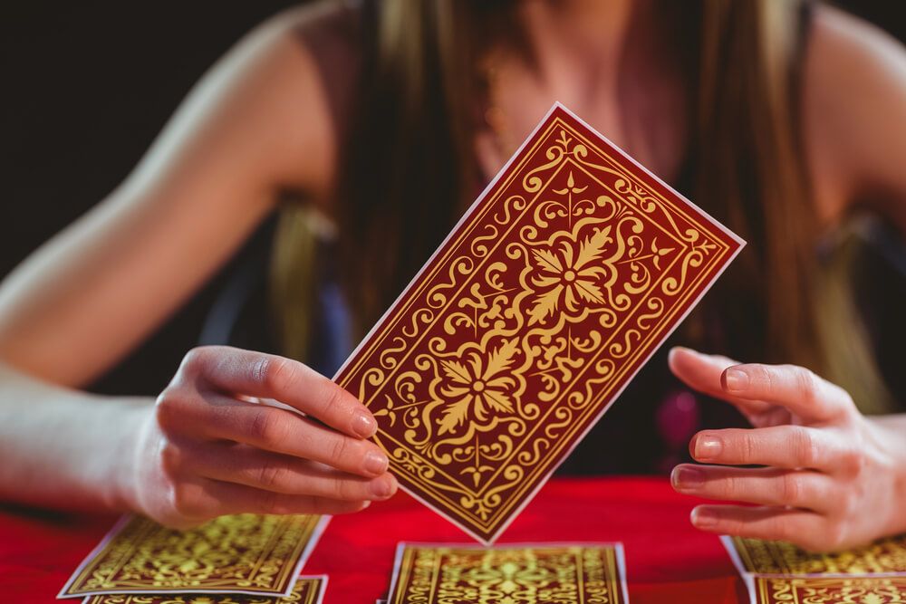 Tarot card being held up.