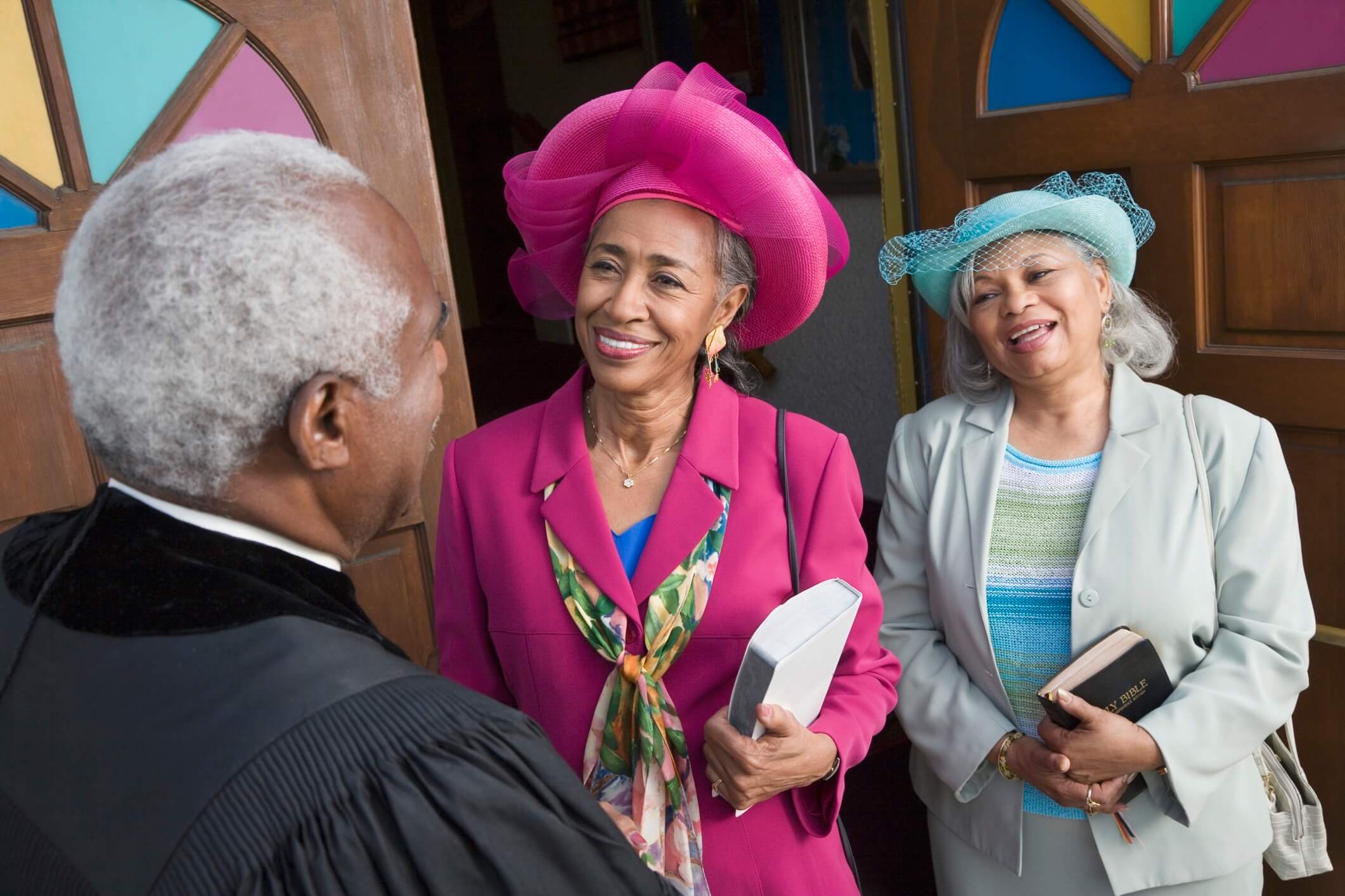 A minister welcoming people to church