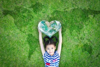 A girl holding a heart for believers and non-believers alike